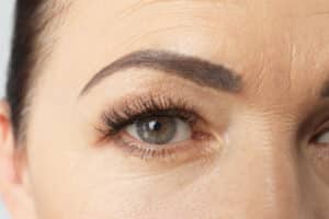 Close-up of a person's eye and eyebrow to illustrate brow lift effects.