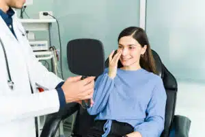 Woman happy about her rhinoplasty results, in this case, a septorhinoplasty meant to fix her previously deviated septum.