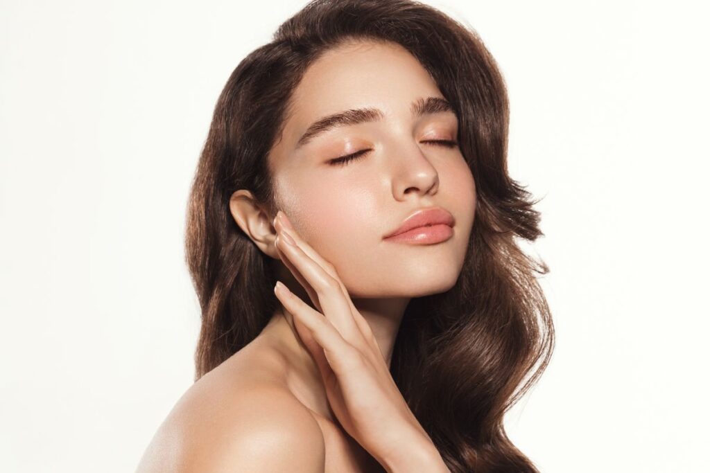 Woman with plump, defined lips showing natural-looking results after hyaluronic acid lip filler treatment.