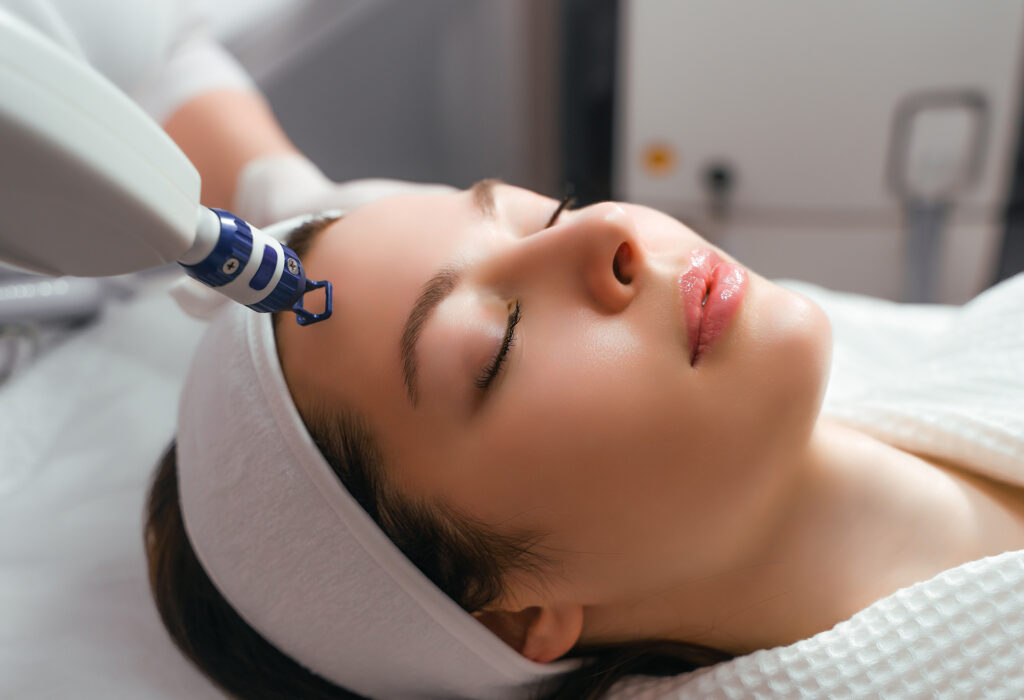Patient receiving V-Beam laser treatment on face to reduce bruising and redness during post-operative recovery